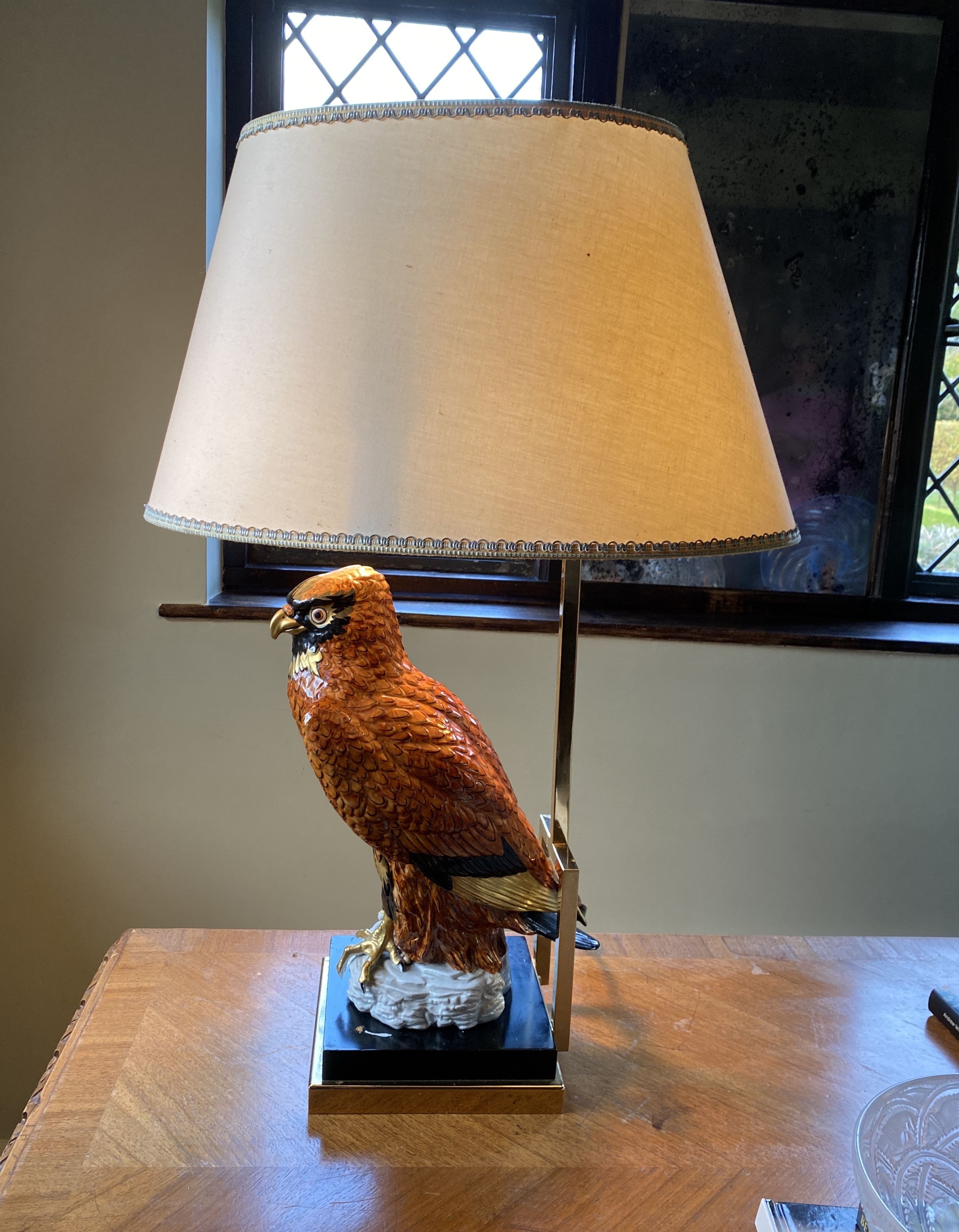 A Continental porcelain owl lamp base, with lacquered brass mounts, height of base 45cm